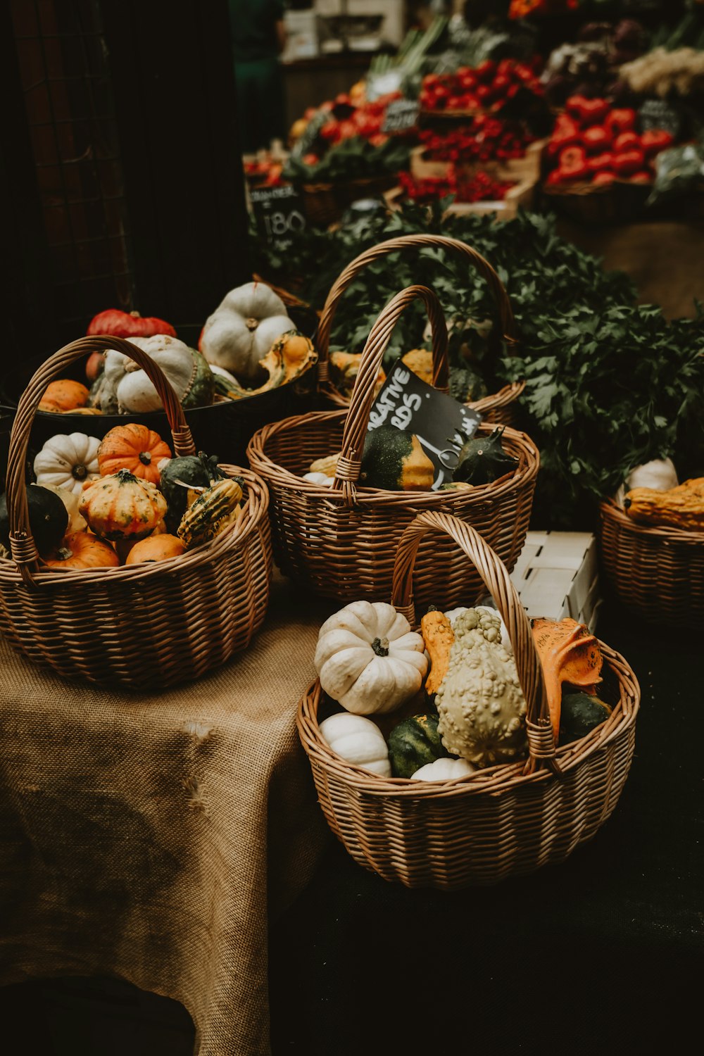 a table topped with baskets filled with vegetables