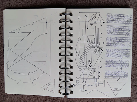 Close-up of a notebook filled with algebraic expressions and diagrams