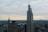 A cityscape featuring tall skyscrapers with modern architecture, set against a cloudy sky. The foreground displays prominent buildings with the MetLife building recognizable by its logo.