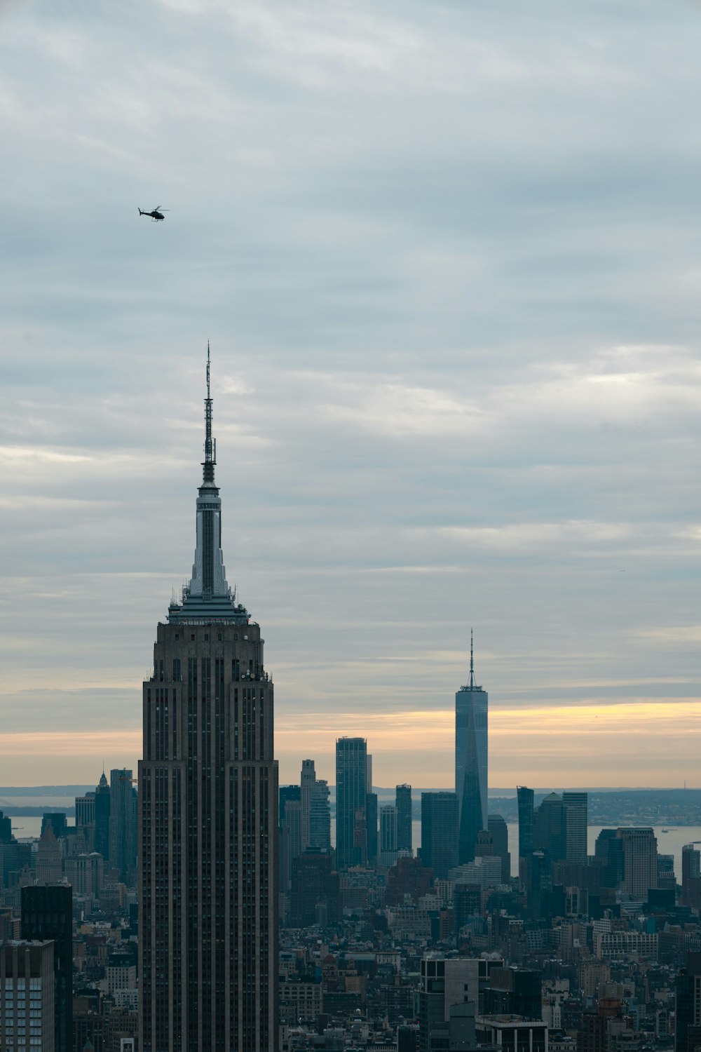 a plane flying over a large city with tall buildings