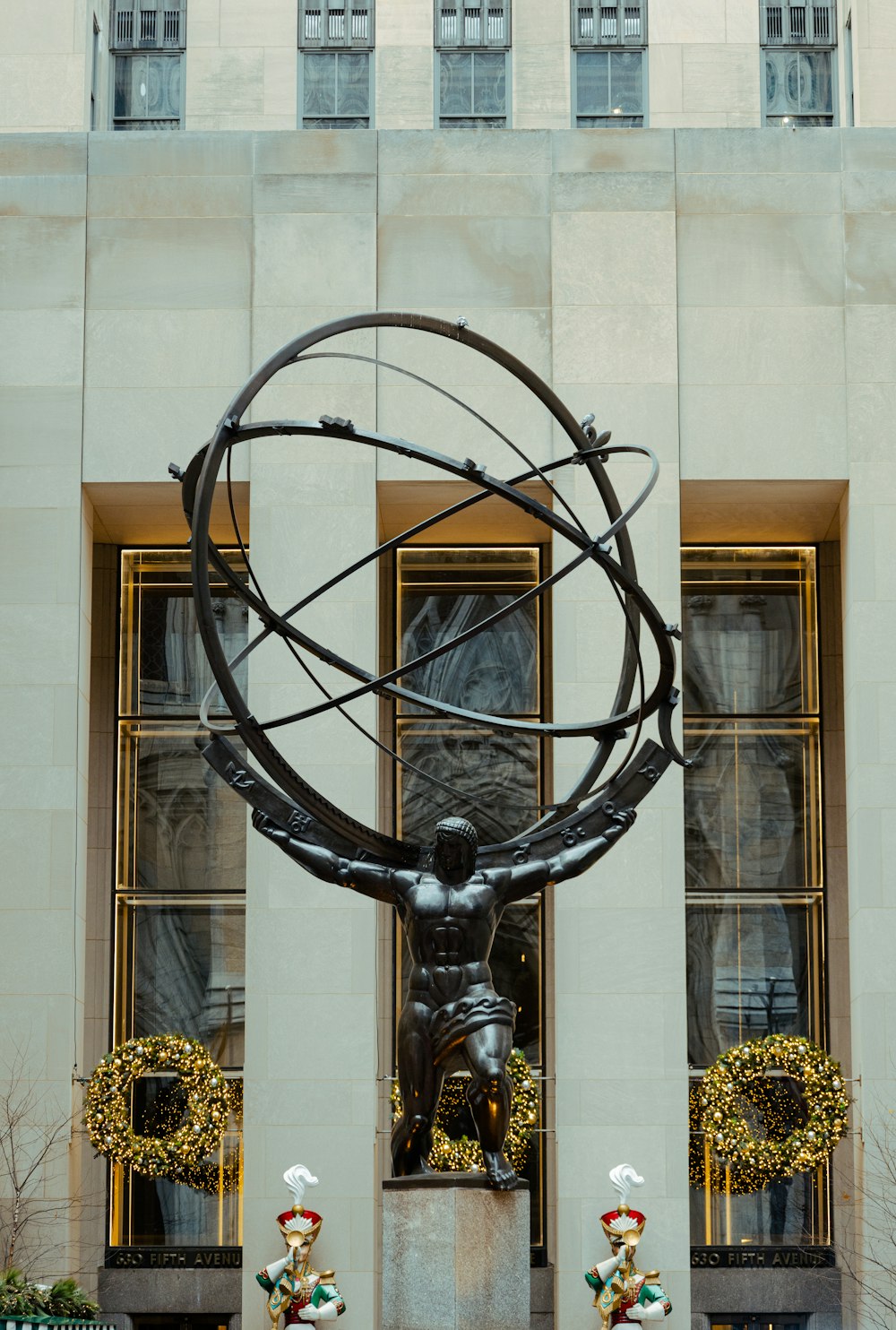 a statue in front of a building with windows