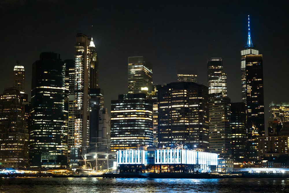 a city skyline at night with skyscrapers lit up