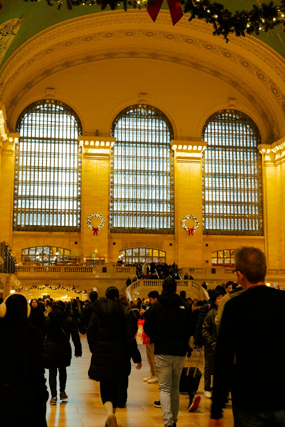 a group of people walking through a train station