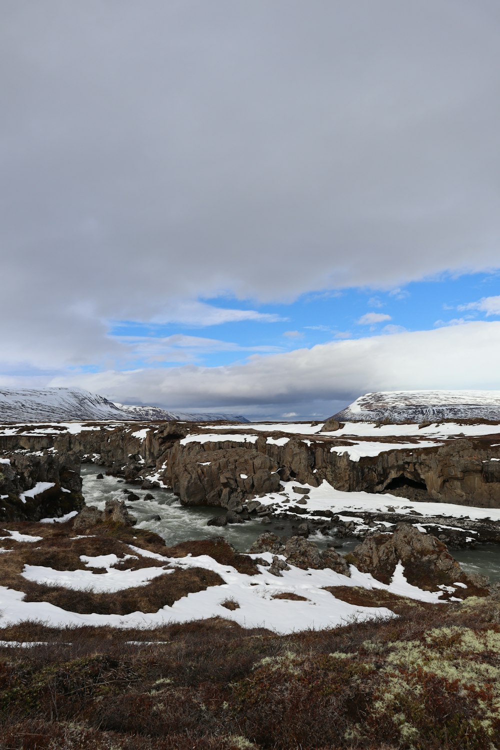 a river running through a snow covered field