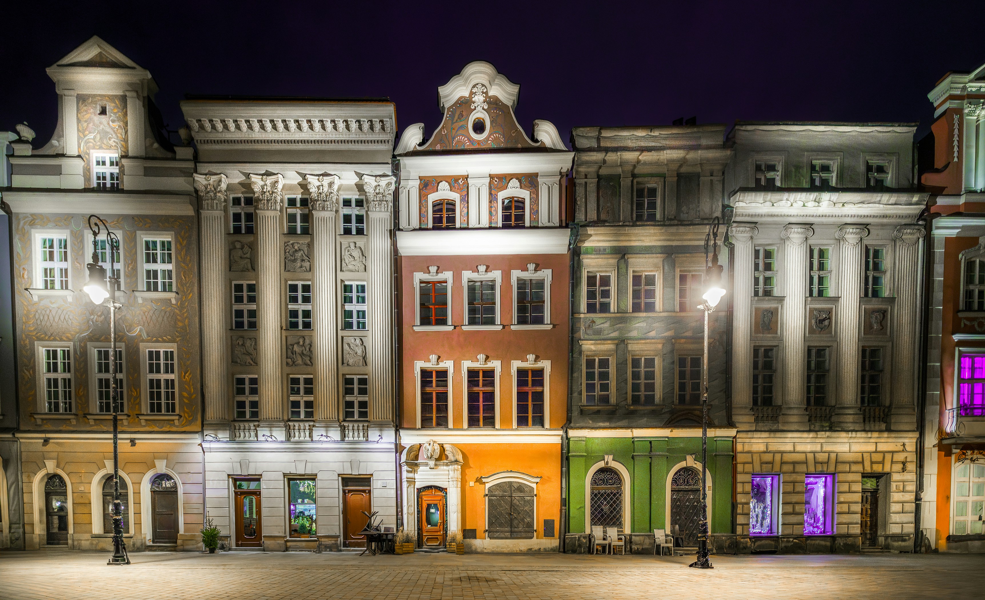 a large building with a clock tower at night