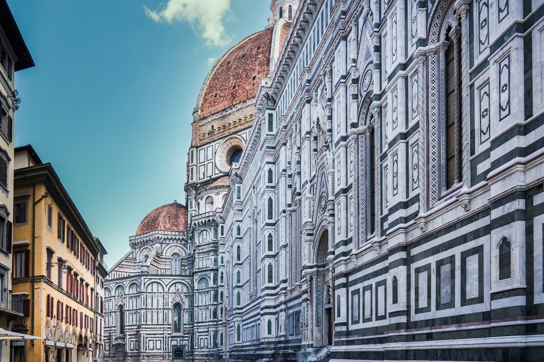 a row of buildings with a blue sky in the background, Florence city center. A fragment of the urban development. Mediter
