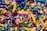 A colorful assortment of keychains featuring small sneaker and basketball designs, with various branding labels. The items are densely packed, displaying a mix of shapes and vibrant colors such as yellow, green, blue, red, and black.