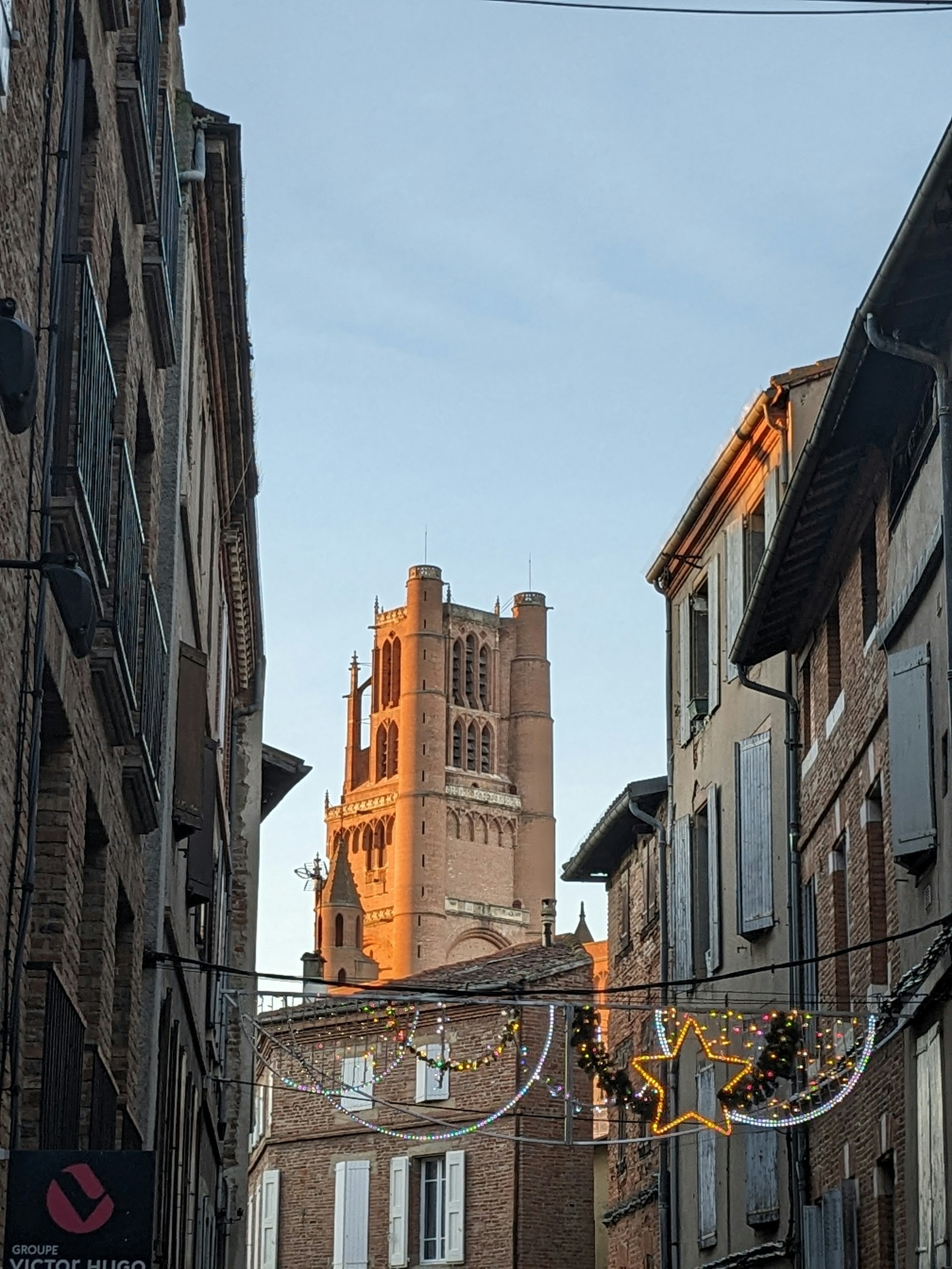 a city street with a clock tower in the background