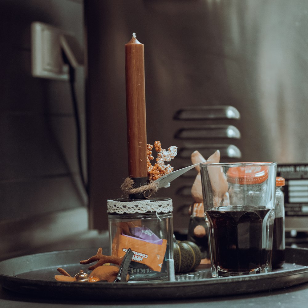 a candle is sitting on a tray with other items