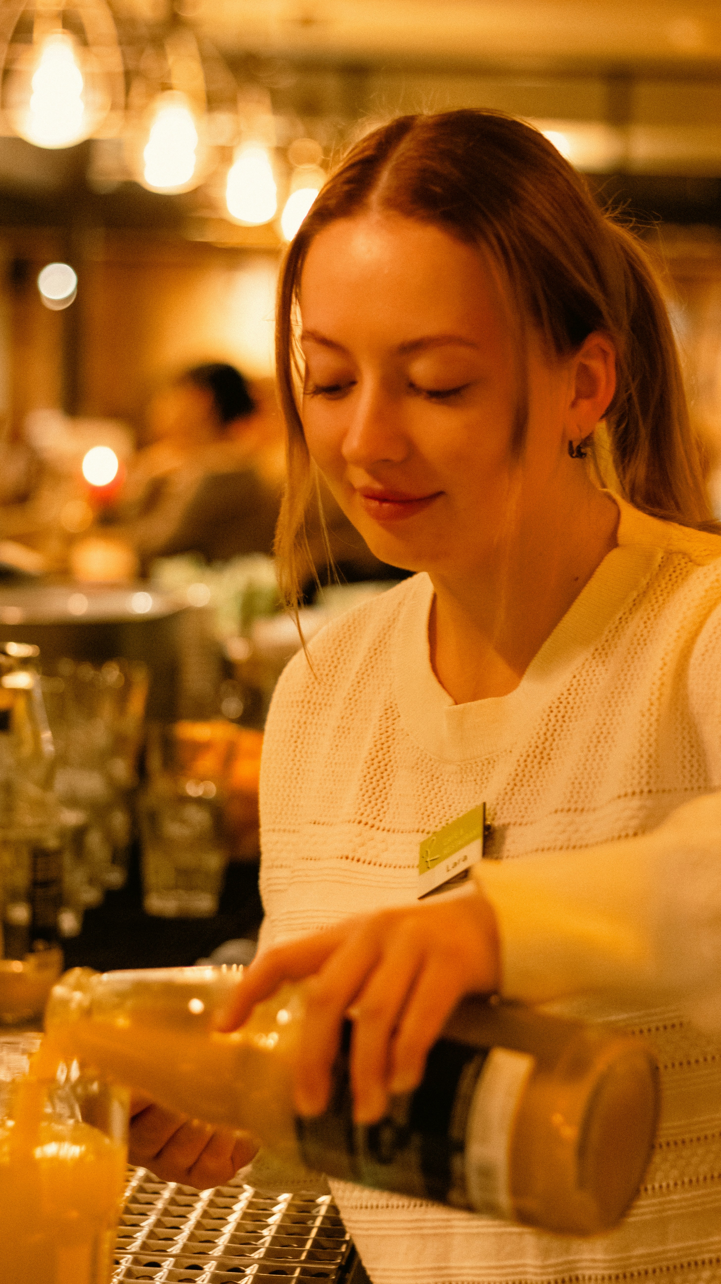a woman pouring a glass of orange juice
