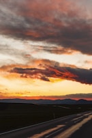 A vibrant sunset over a winding road in the Andes.