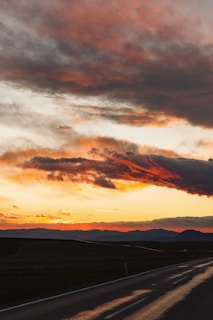 A vibrant sunset over a winding road in the Andes.