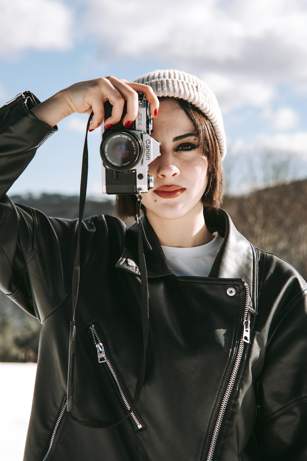 a woman taking a picture with a camera