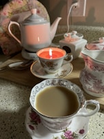 An inviting tea setup featuring a porcelain cup with steam rising, set against a backdrop of blooming jasmine.