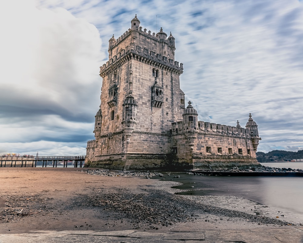 a very tall tower sitting on top of a sandy beach