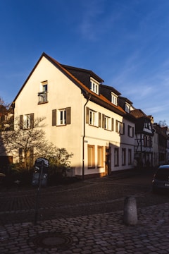 a large white house sitting on the side of a road