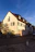 Cozy European-style house exterior bathed in warm afternoon light.