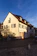 Cozy European-style house exterior bathed in warm afternoon light.