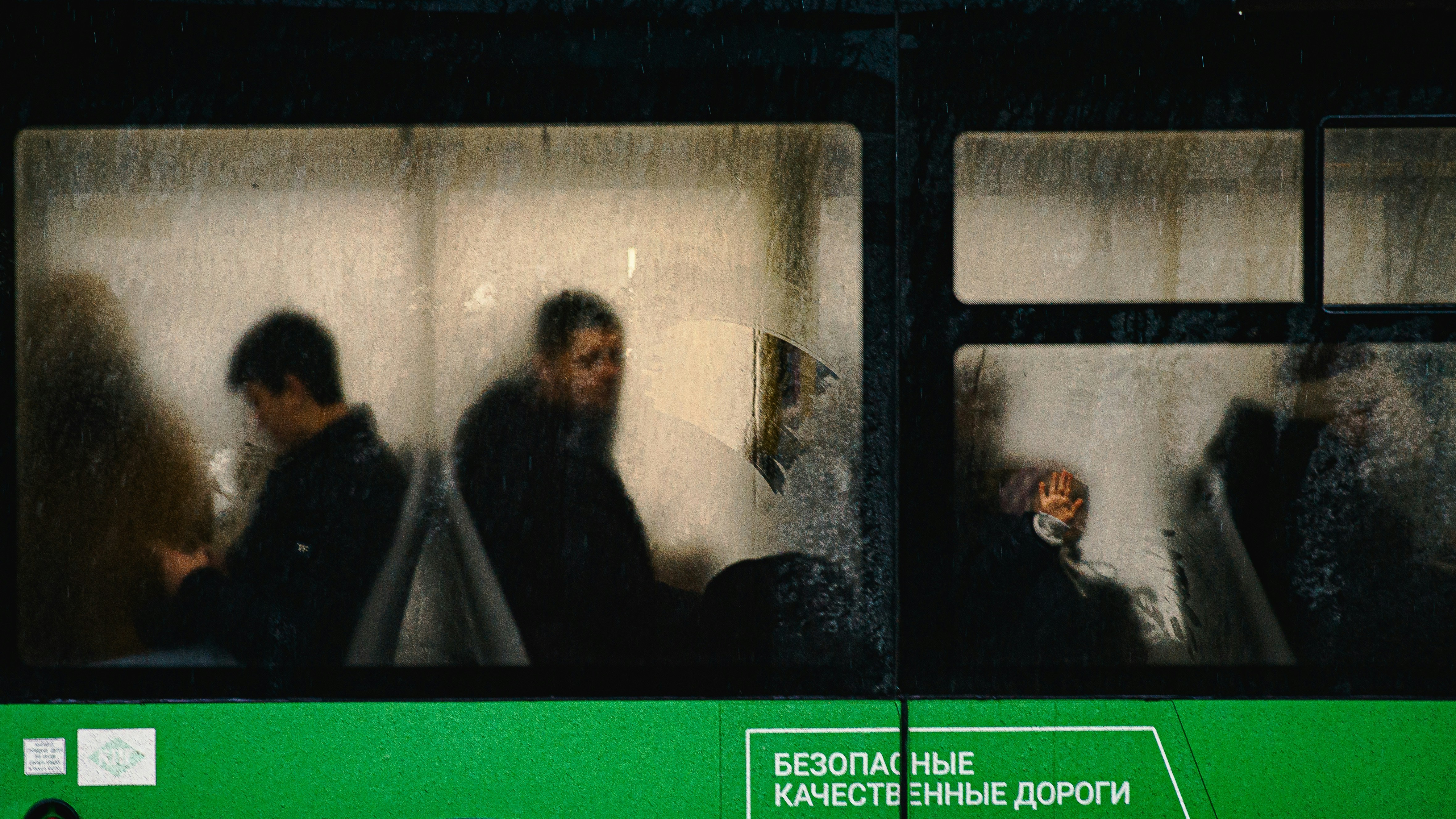 a group of people sitting on a train next to each other