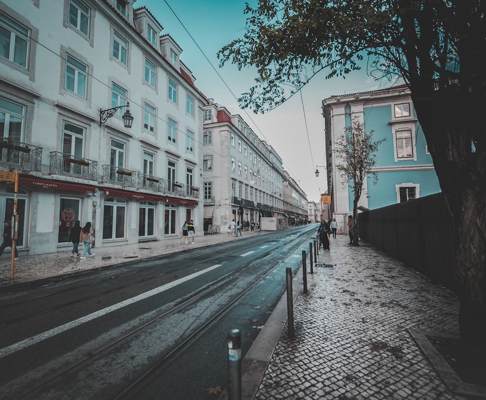 a city street with a few people walking on the sidewalk