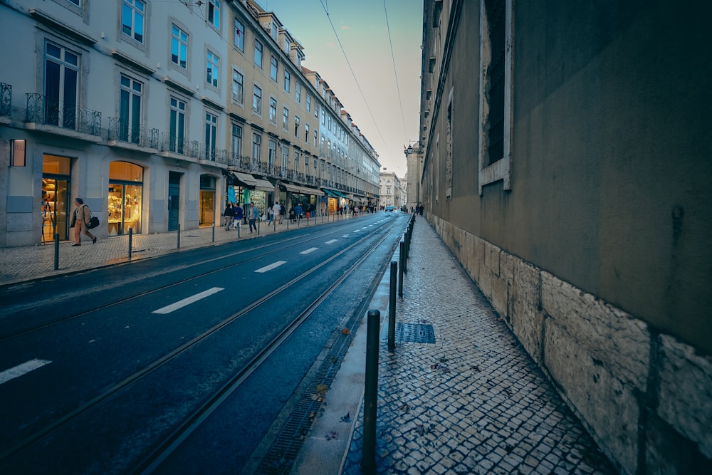 a city street with people walking on the sidewalk