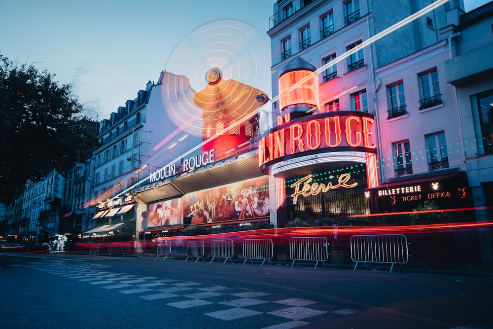 a large building with a neon sign on the side of it