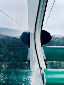 Inside view of a well-maintained taxi with comfortable seating and mountain views.