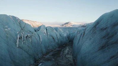 A breathtaking view of a glacier with hikers exploring the icy terrain
