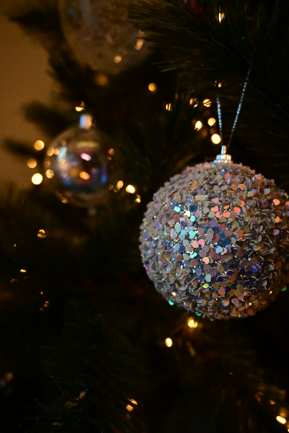 a christmas ornament hanging from a christmas tree