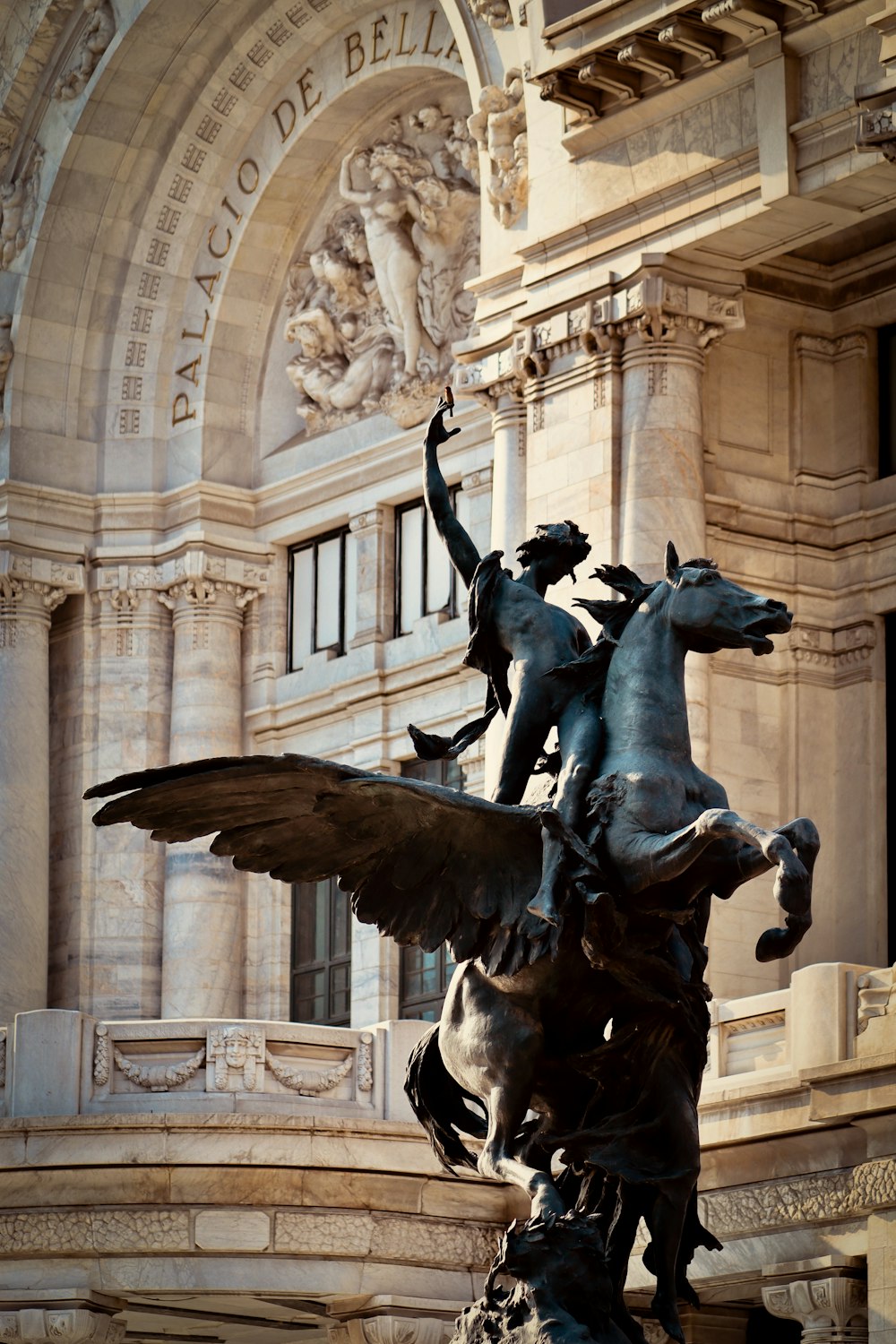 a statue of a horse and a dog in front of a building