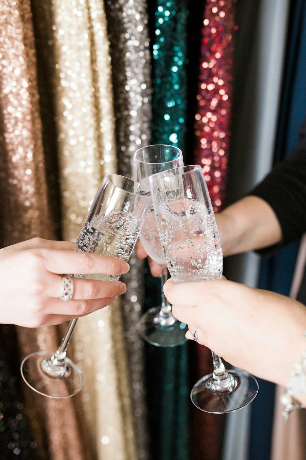 a couple of people that are holding wine glasses