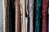 a bunch of different colored sequins hanging on a wall