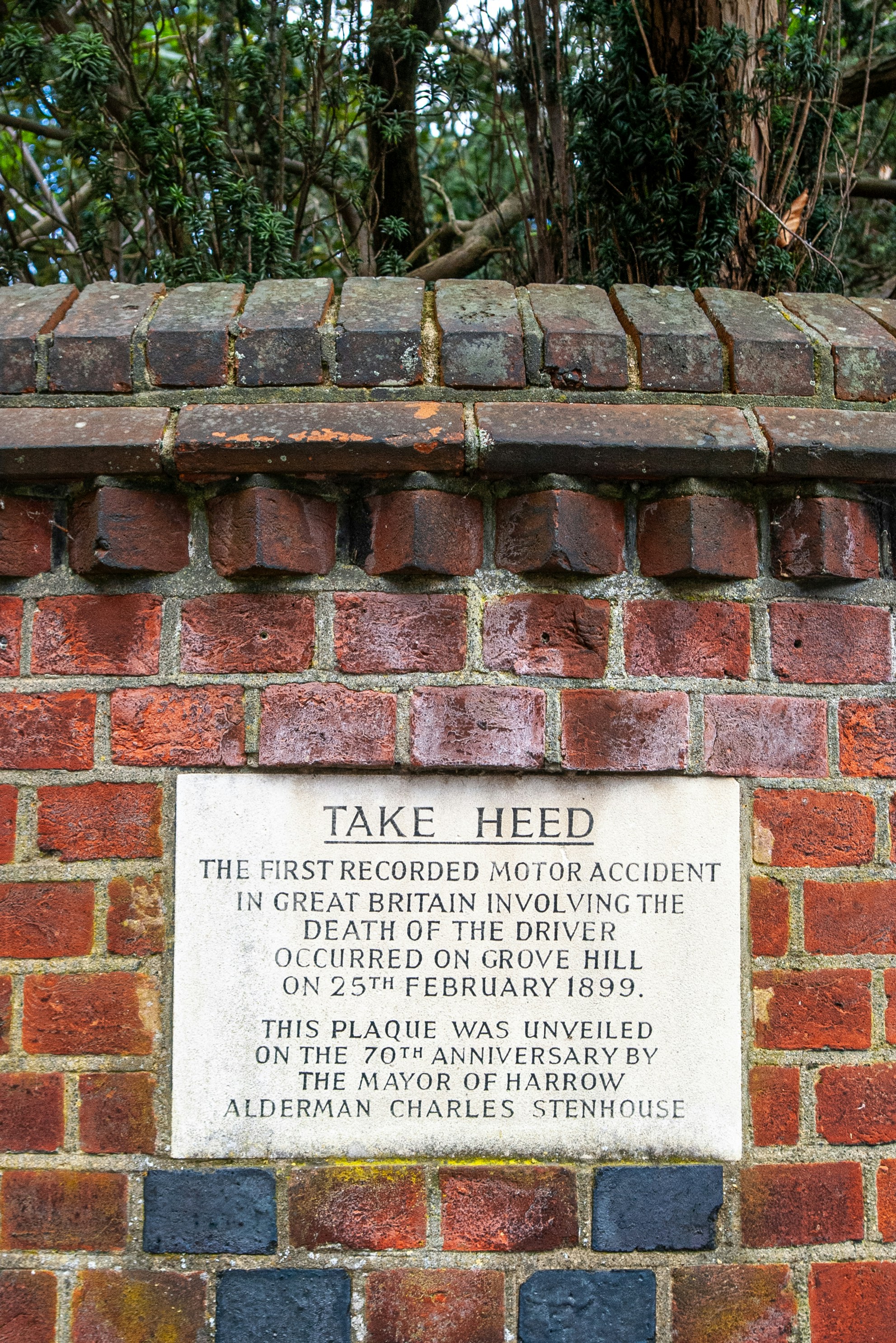 a brick wall with a plaque on it