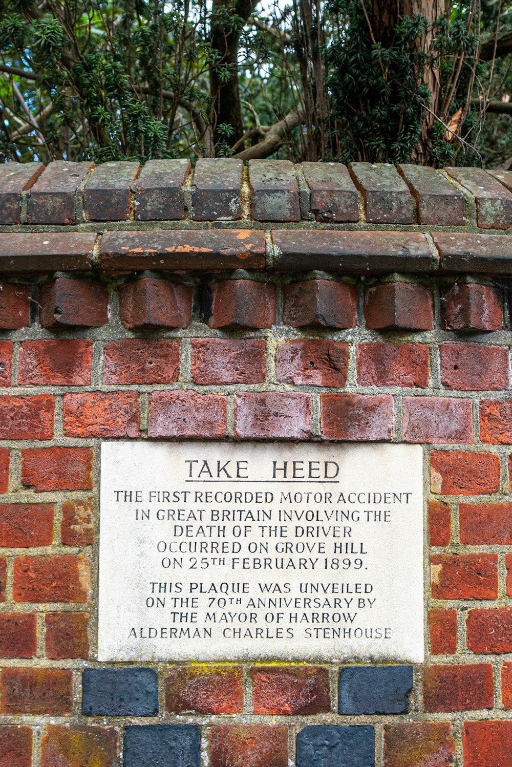 a brick wall with a plaque on it