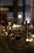 A cozy model train setup with miniature landscapes and tiny passengers, glowing warmly under soft lighting.