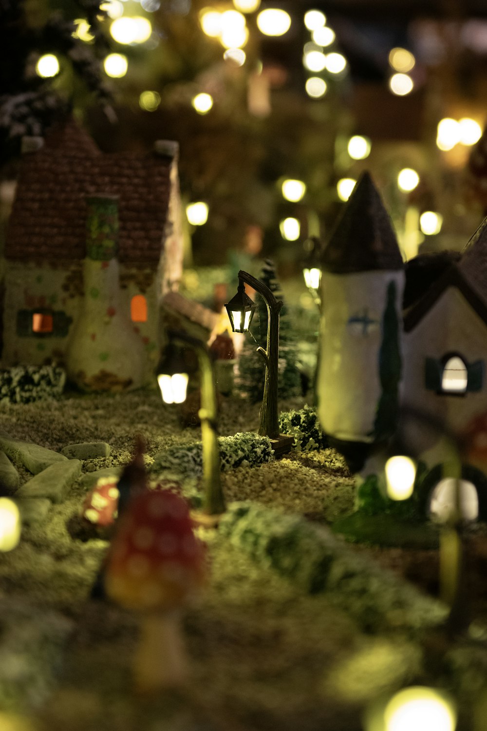 a close up of a christmas village with lights