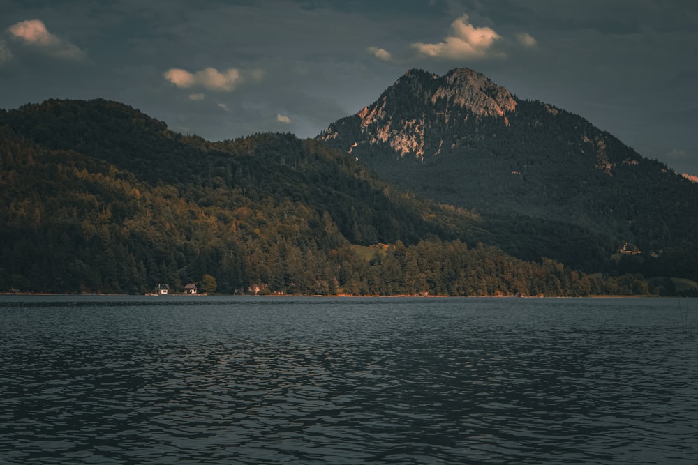 a large body of water with a mountain in the background