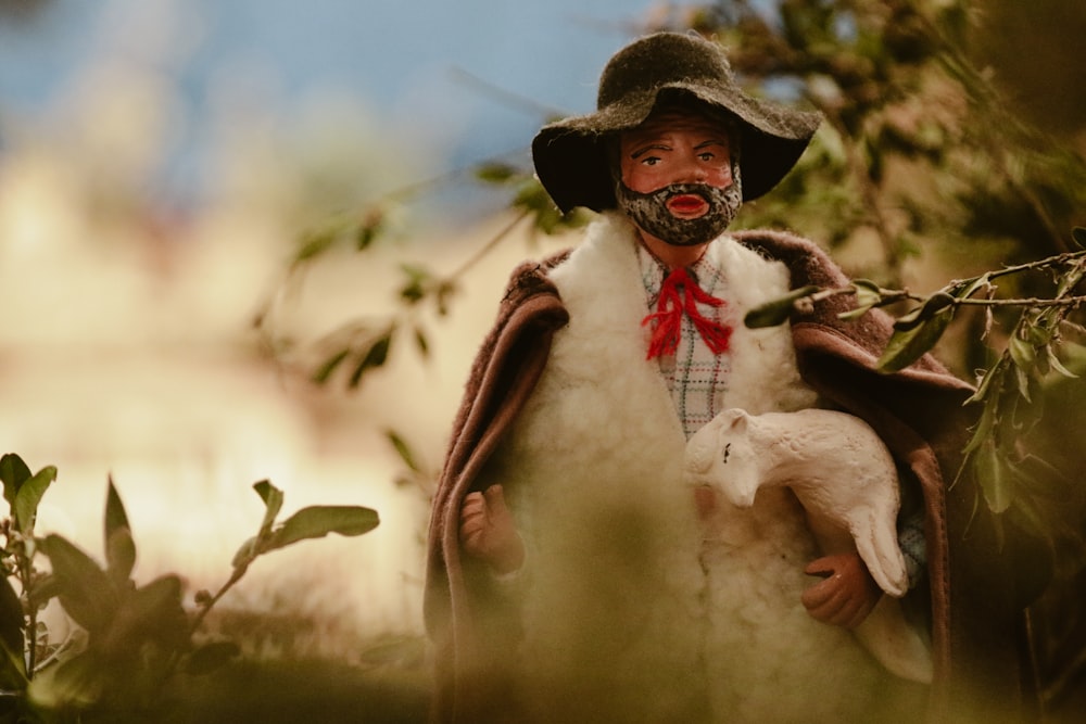 a figurine of a man with a goat on his shoulder