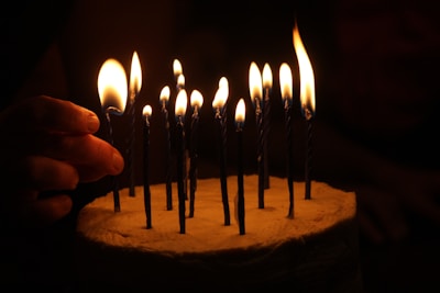 Lucila holding a cake with lit candles, ready to make a wish