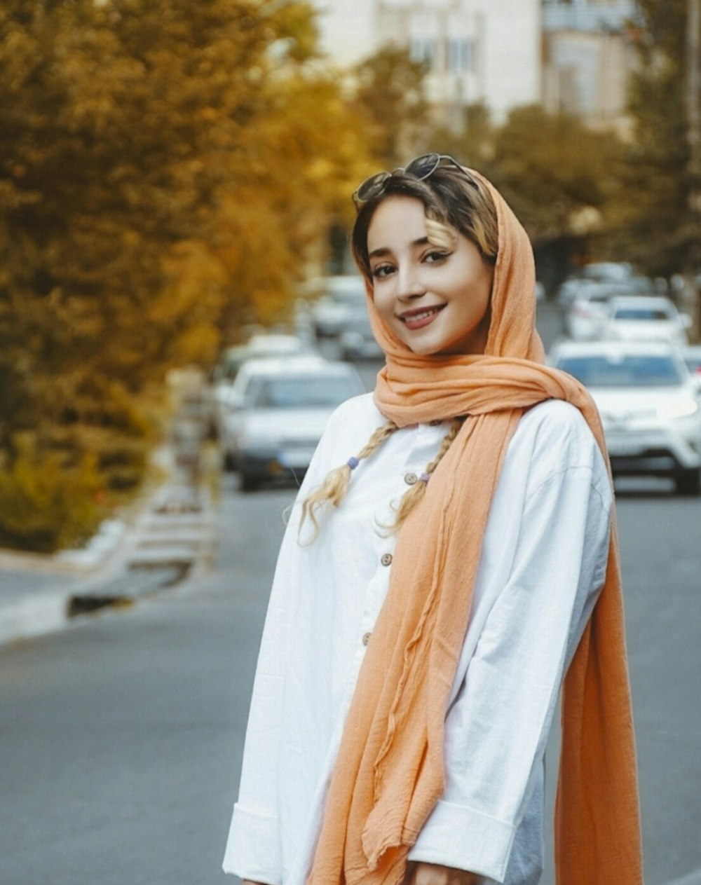 a woman standing on the side of a road