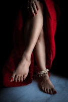 A set of semipermanent polished toenails in vibrant red, perfectly done and glossy.