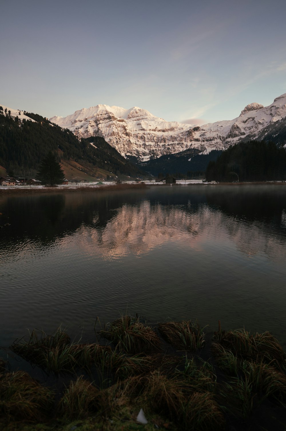 a body of water with mountains in the background