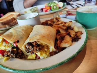 Freshly made breakfast wrap with vibrant greens and a side of crispy hash browns.