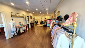 A personal shopper assisting a client in selecting clothing in a stylish boutique.