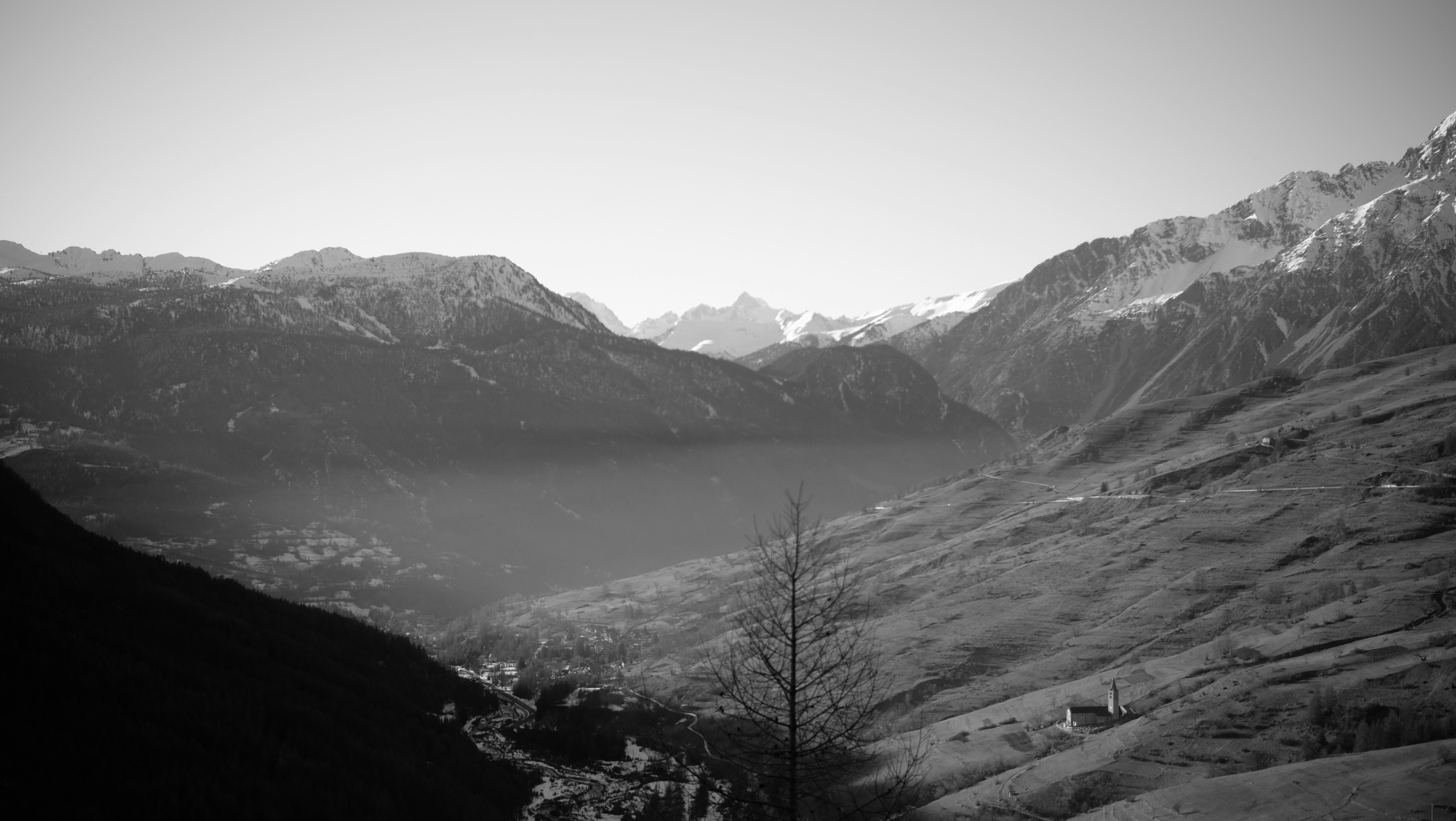 a black and white photo of a mountain range