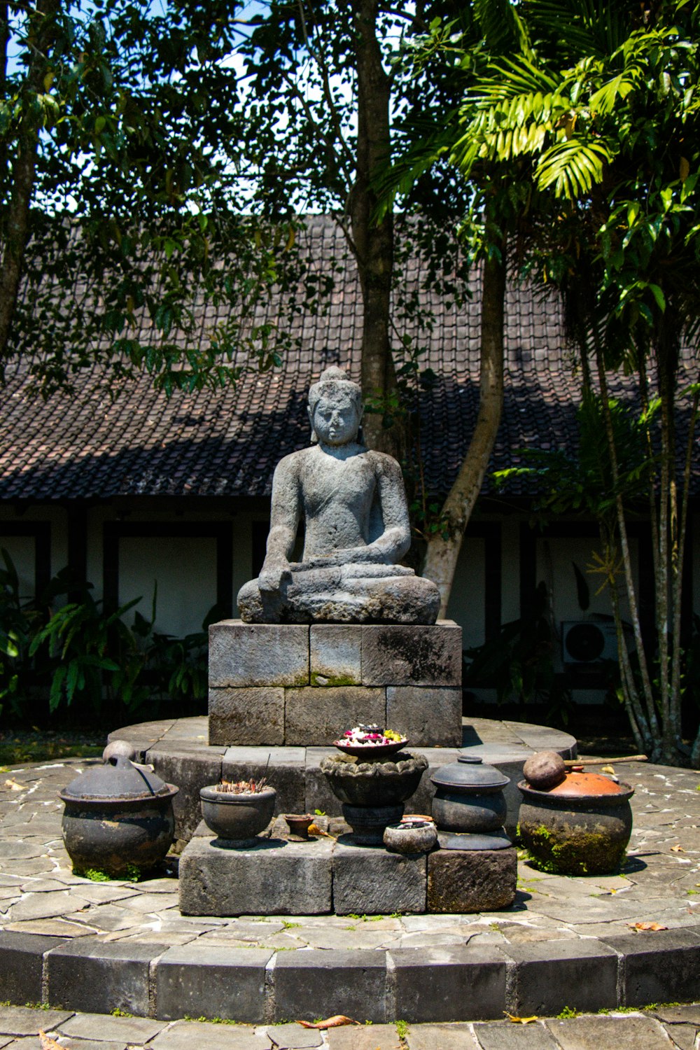 a statue of a person sitting on top of a fountain