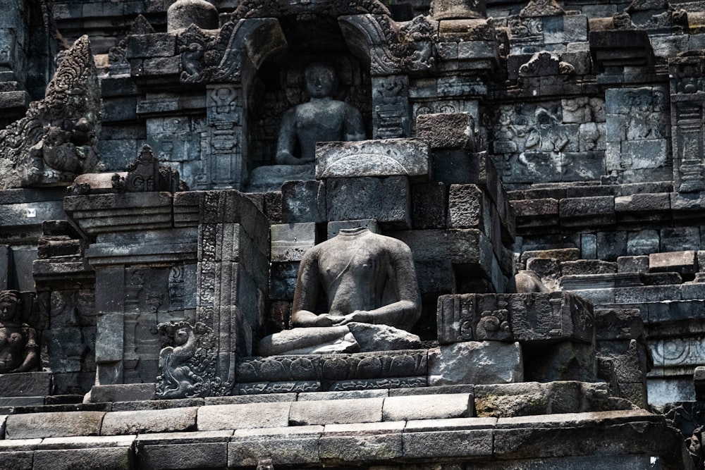 a statue of a person sitting in a niche