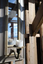 Black metal wall sconce mounted on a whitewashed rustic wall enhancing farmhouse decor.