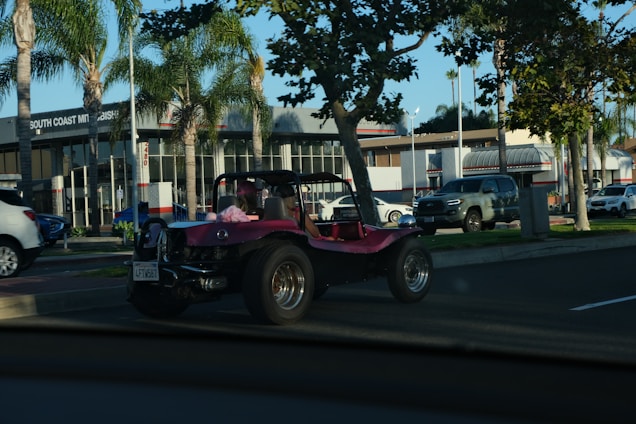 A friendly car and motorcycle dealership with a variety of vehicles displayed outside on a sunny day.