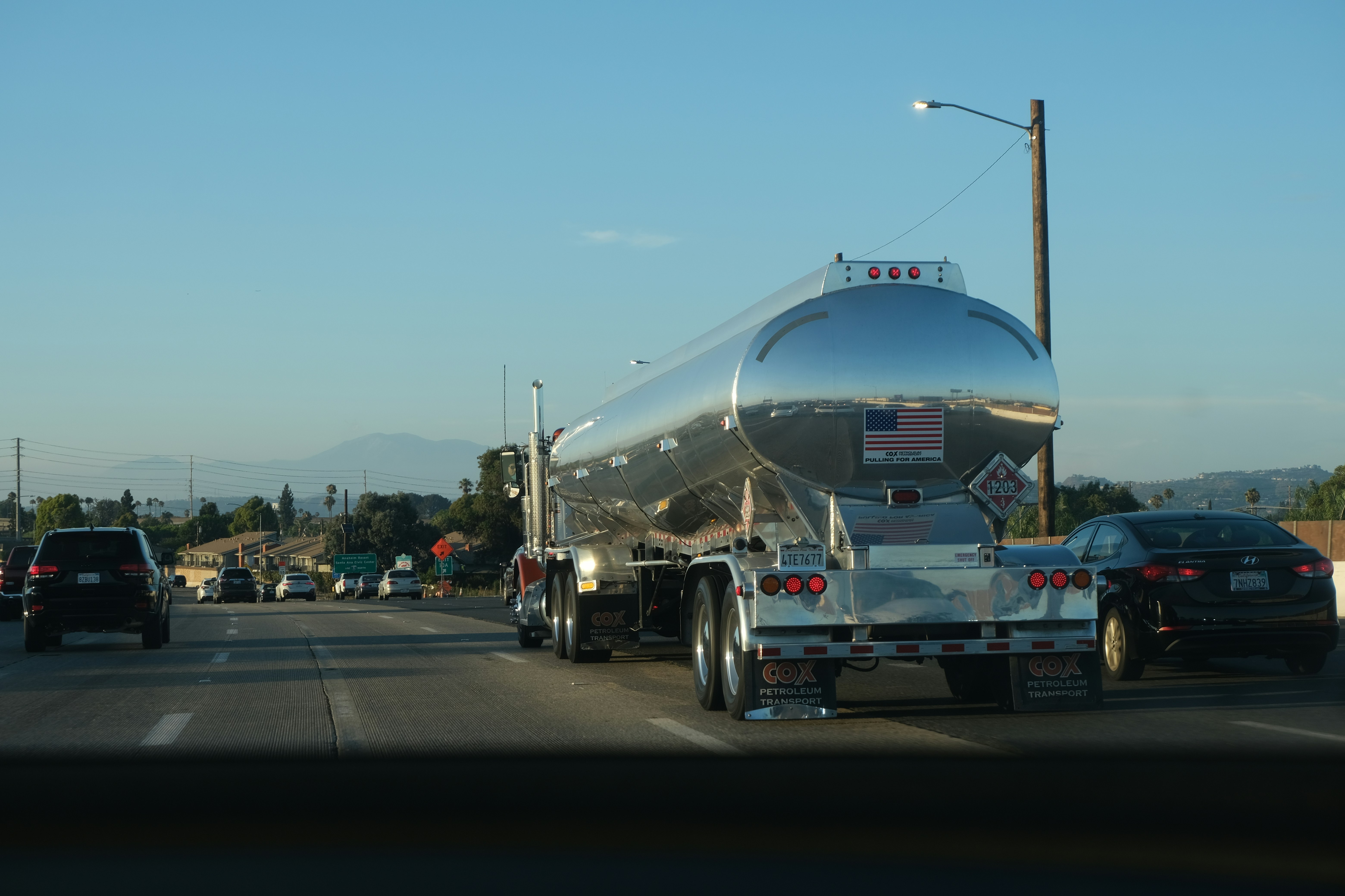 Commercial freight truck on open highway, clear sky, professional logistics transport